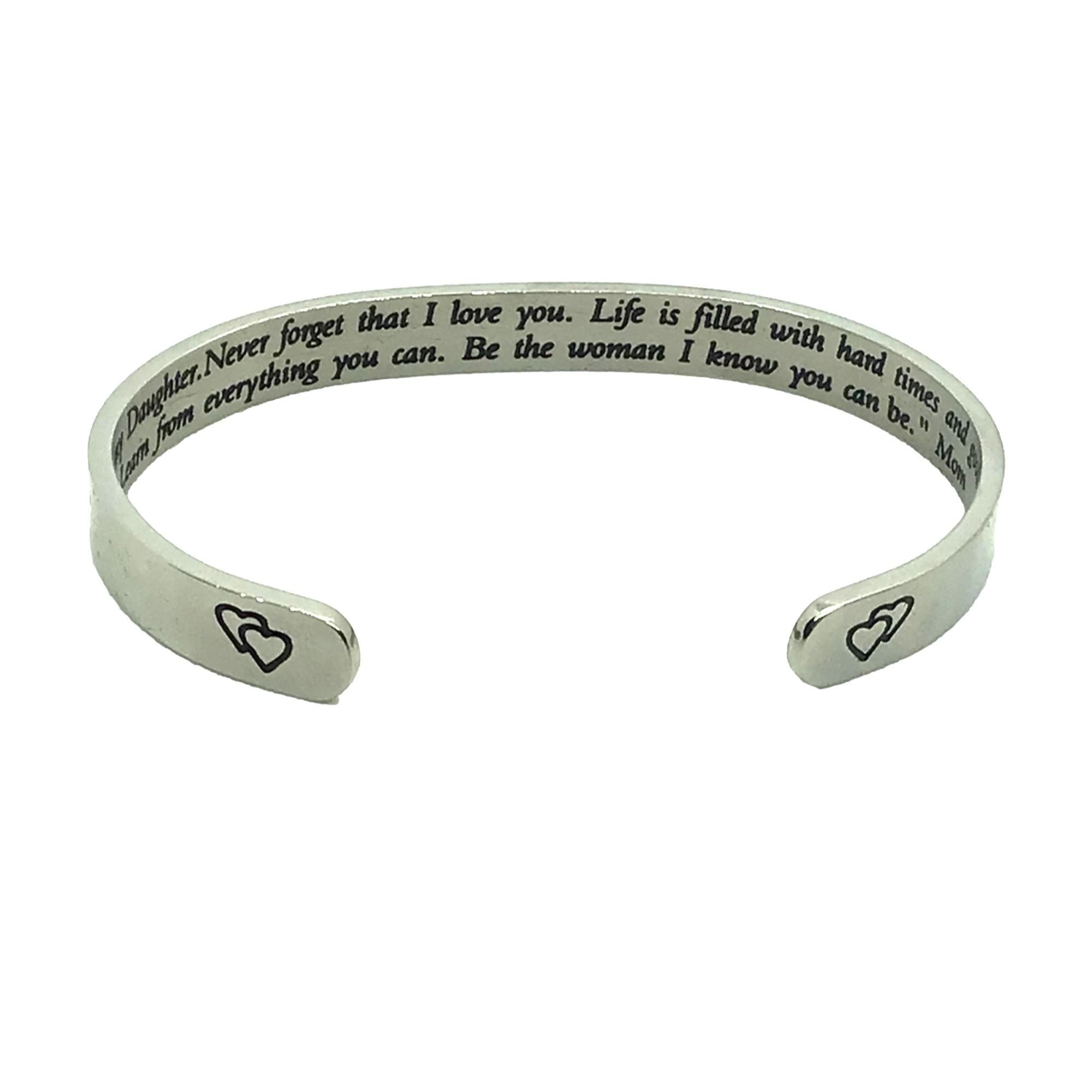 Silver bracelet with engraved text and heart symbols on a white background