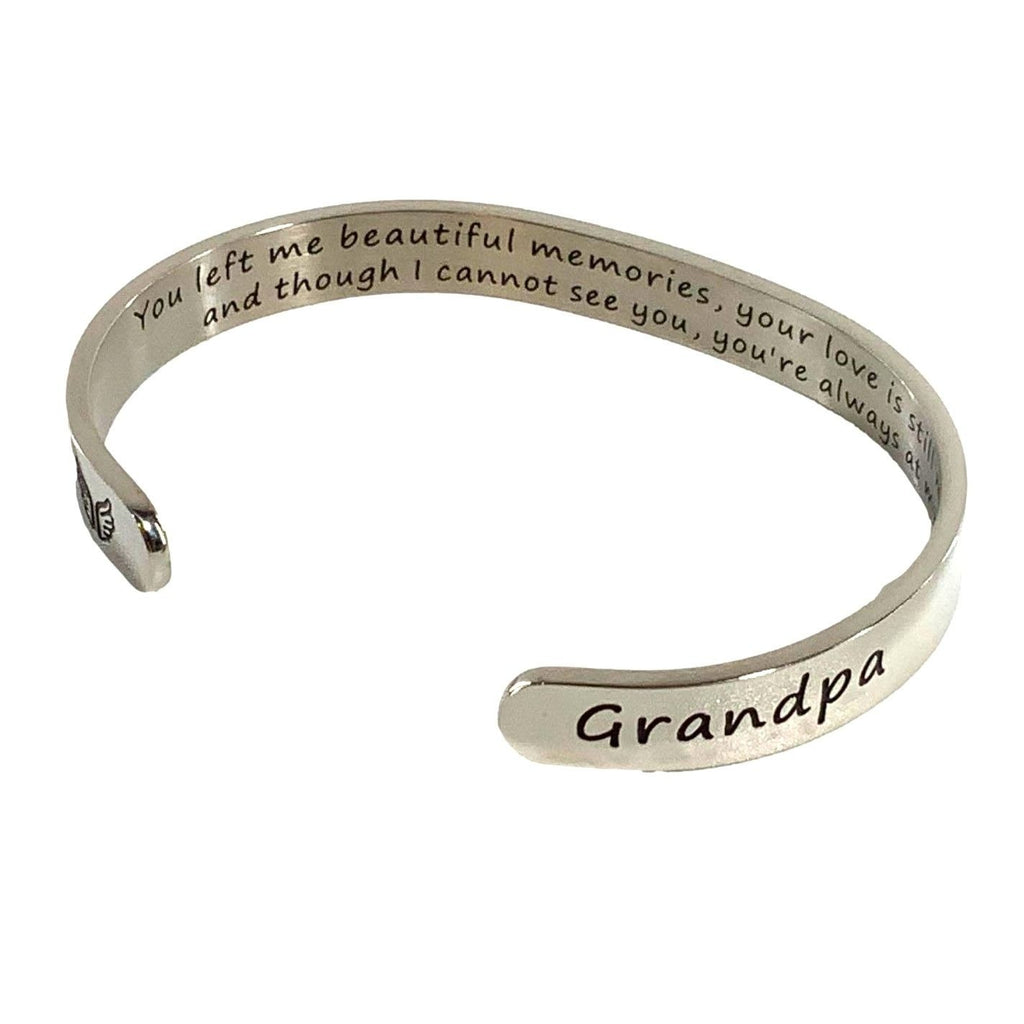 Silver bracelet with engraved message on a white background