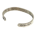 Silver bracelet with engraved message on a white background