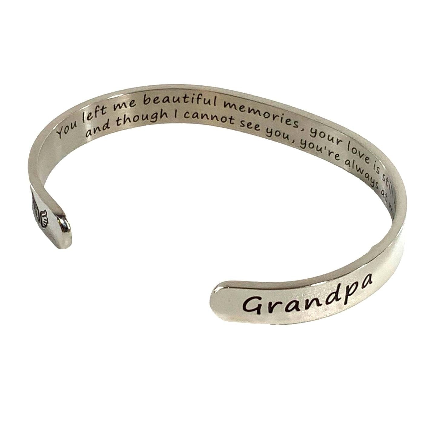 Silver bracelet with engraved message on a white background