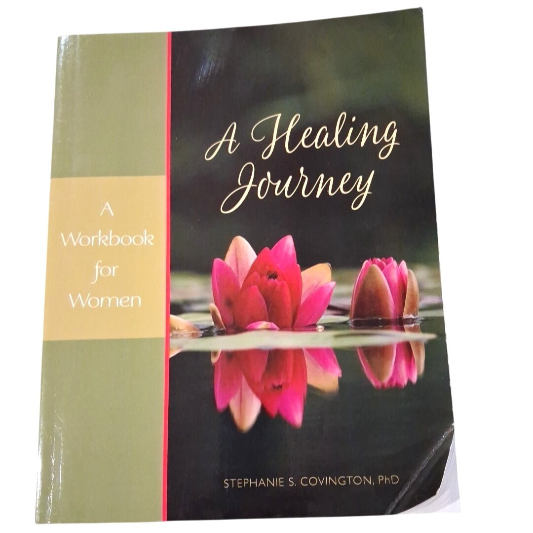Book titled 'A Healing Journey: A Workbook for Women' by Stephanie S. Covington, PhD with pink lotus flowers on the cover.