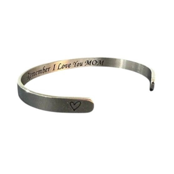 Silver bracelet with 'Remember I Love You MOM' engraving on a white background