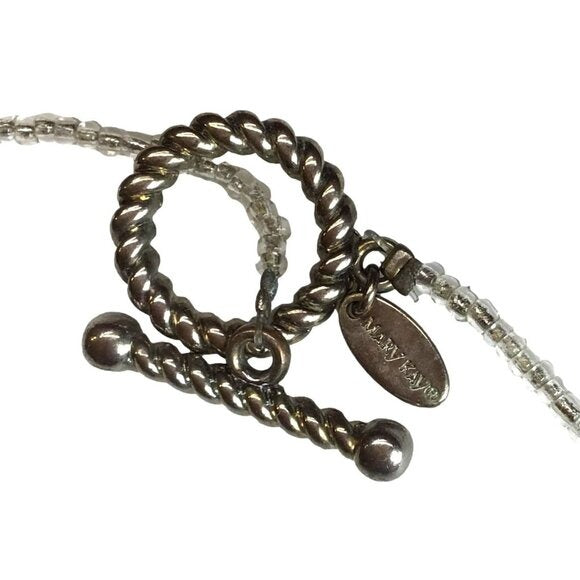 Close-up of a silver bracelet with a tag on a white background
