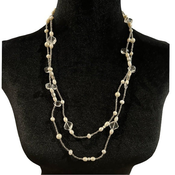 Necklace with pearls and crystals on a black mannequin bust