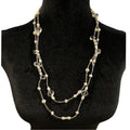 Necklace with pearls and crystals on a black mannequin bust