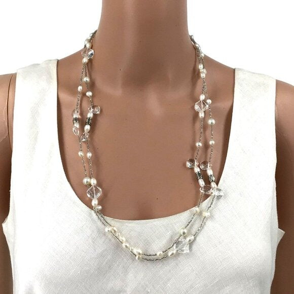 Pearl and crystal necklace on a mannequin with a white top