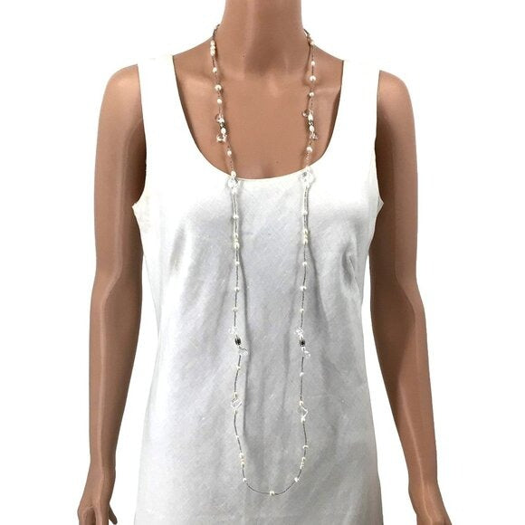 Mannequin wearing a white sleeveless top with a long necklace on a white background