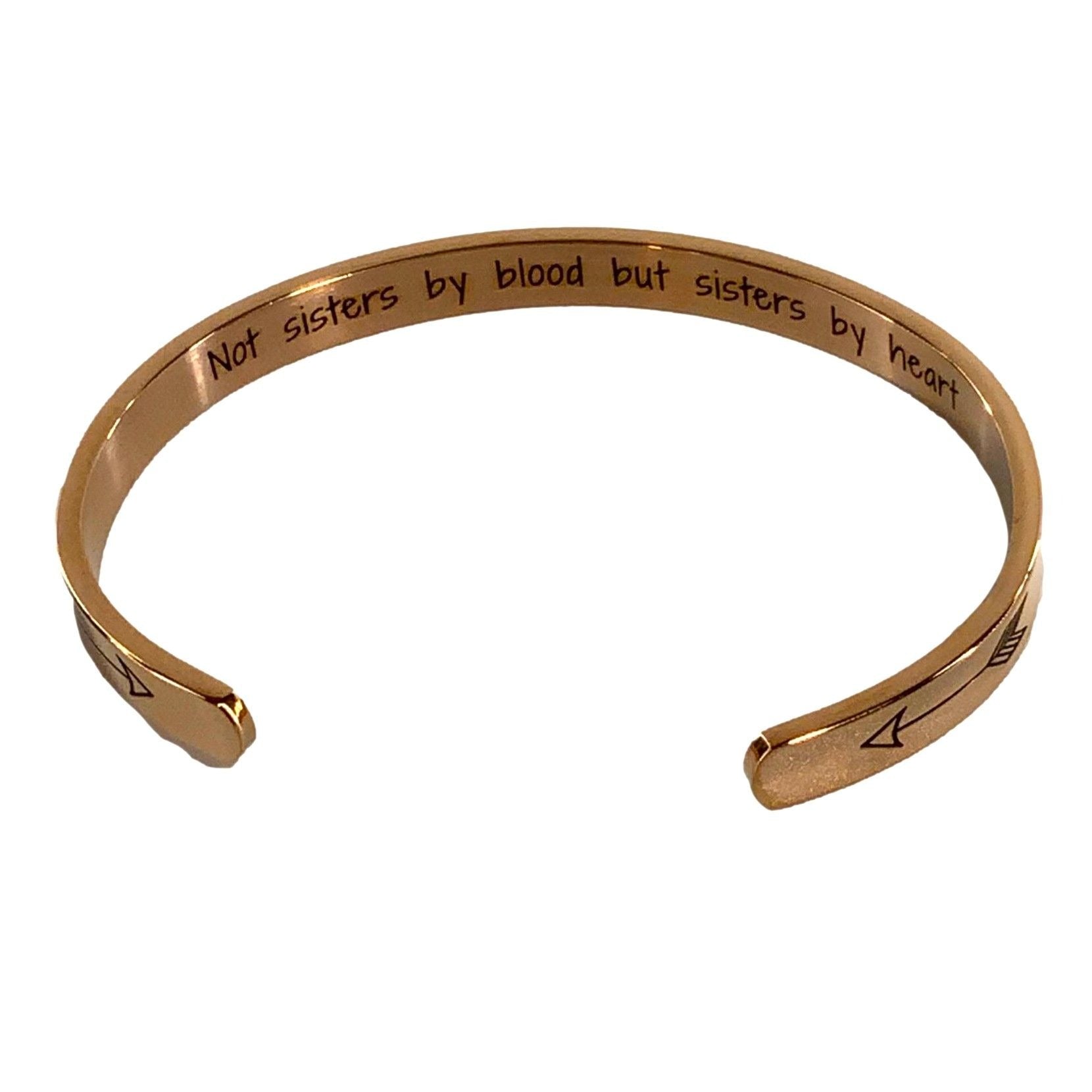Rose gold bracelet with engraved text on a white background