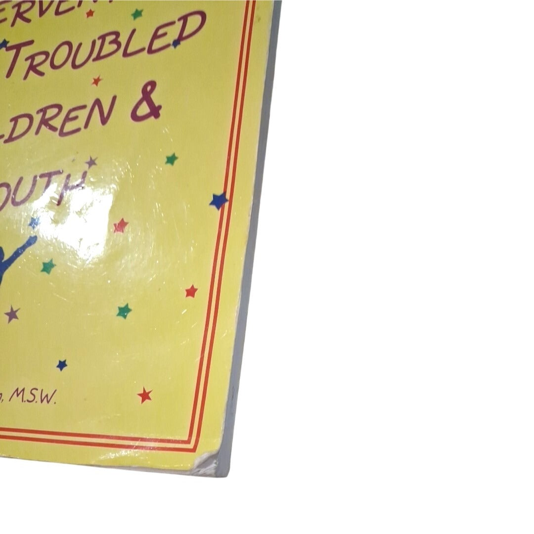 Yellow book or paper with text and colorful stars on a white background