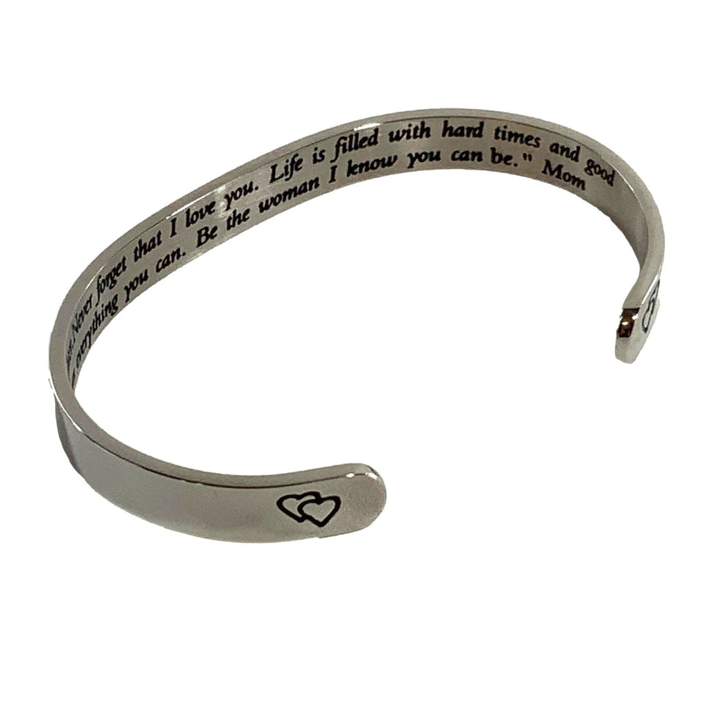 Silver bracelet with engraved message on a white background