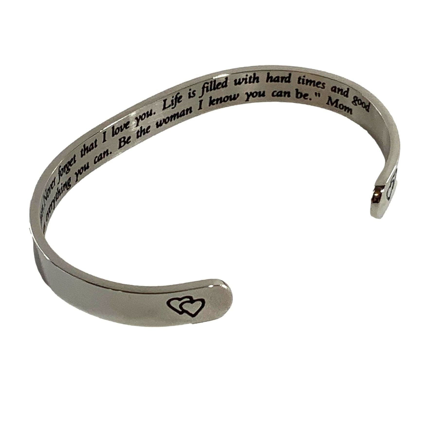 Silver bracelet with engraved message on a white background