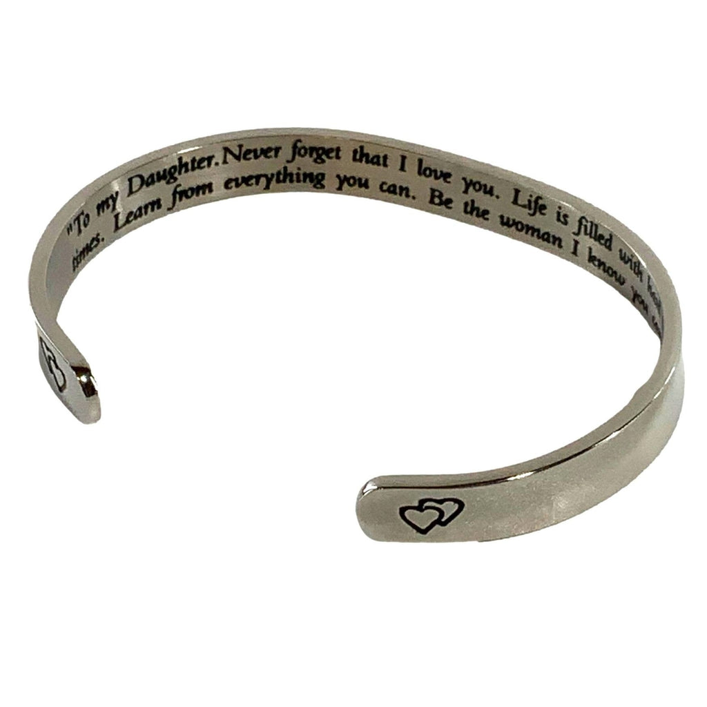 Silver bracelet with engraved message on a white background