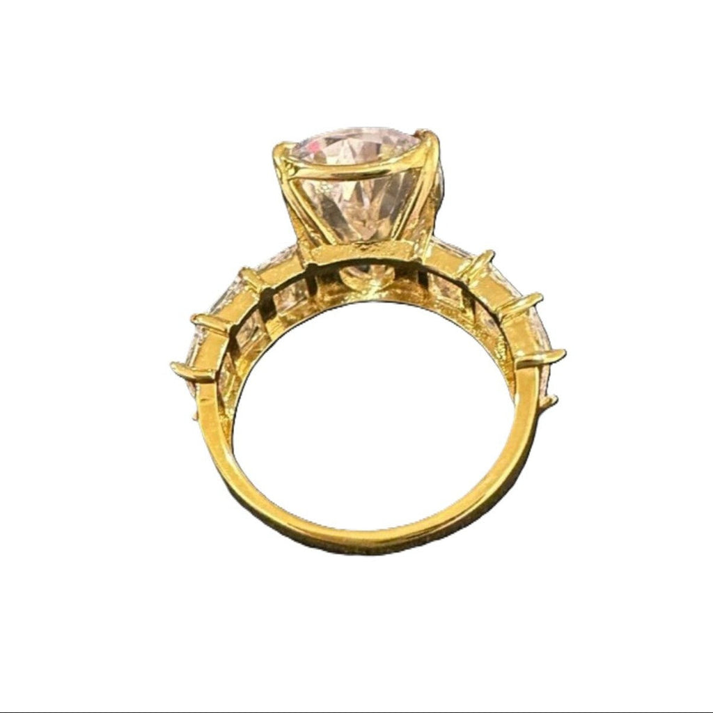 Gold ring with a large pink gemstone on a white background