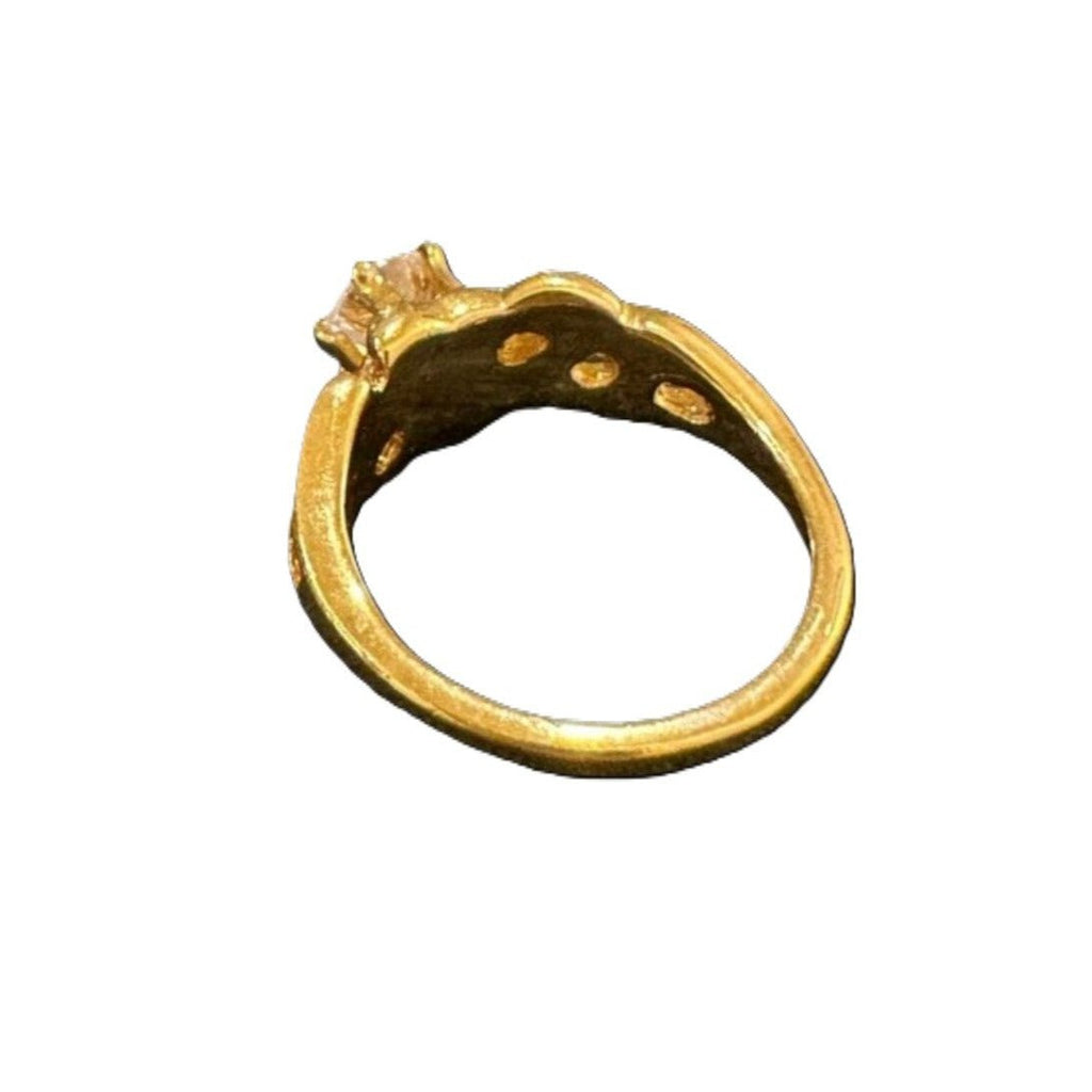 Gold ring with a diamond on a white background