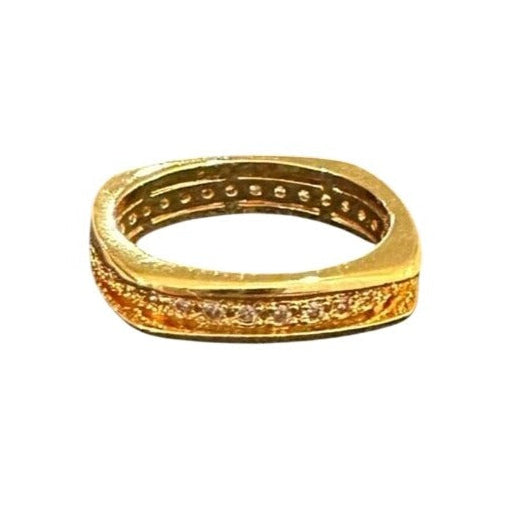 Gold ring with intricate design on a white background