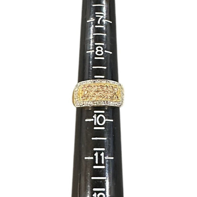 Gold ring on the ring sizer against a white background