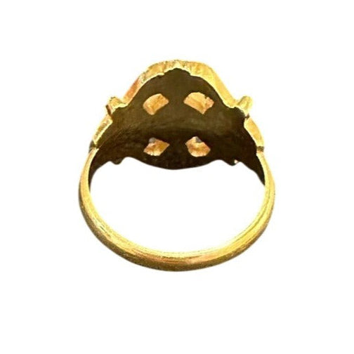 Gold ring with a unique design on a white background