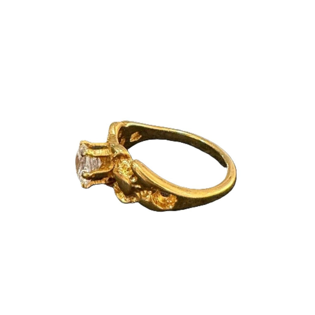Gold ring with a diamond on a white background