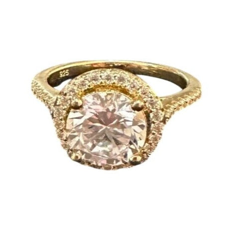 Gold ring with a gemstone on a white background