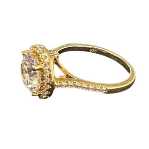 Gold ring with a large diamond on a white background