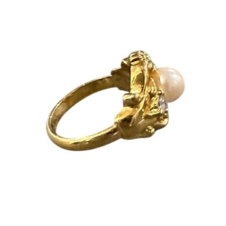 Gold ring with a pearl on a white background