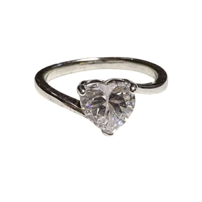 Silver ring with a heart-shaped diamond on a white background