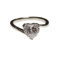 Silver ring with a heart-shaped diamond on a white background