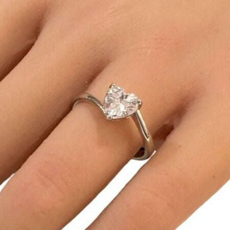 Diamond ring on a hand against a white background
