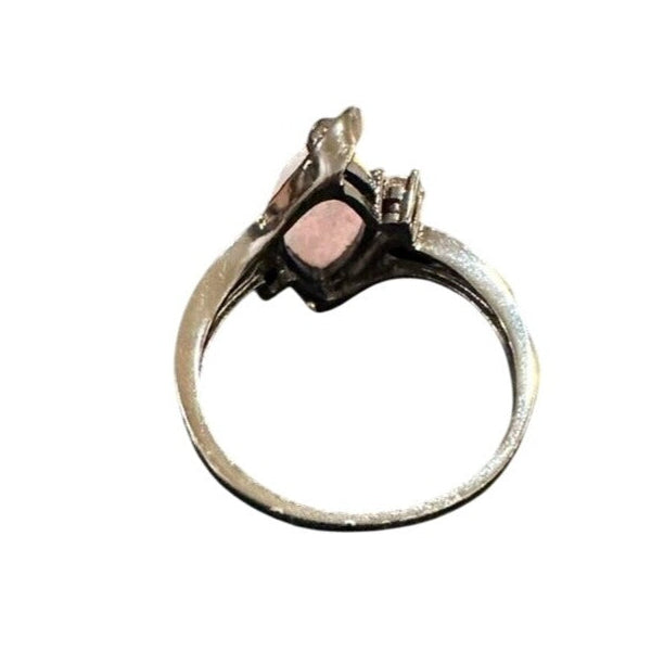 Silver ring with a pink stone on a white background