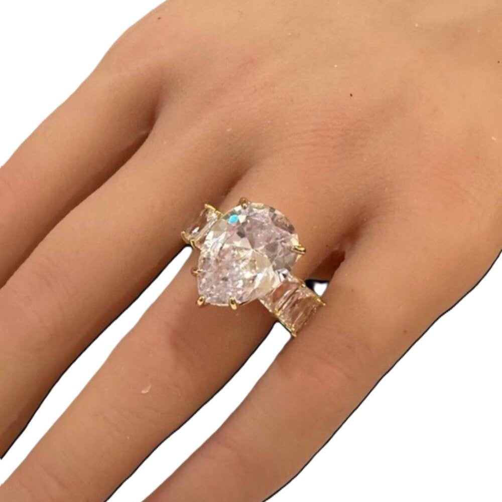 Ring with a large diamond on a hand against a white background