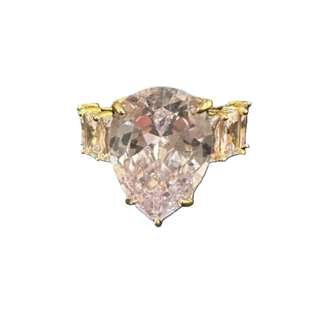 Triangular pink gemstone with gold setting on a white background
