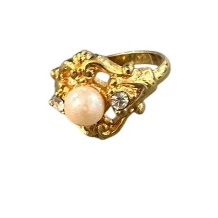gold ring with pearl on white background