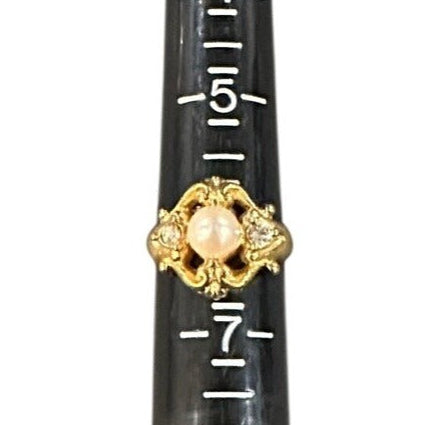 Ring Sizer gold and pearl design on a white background
