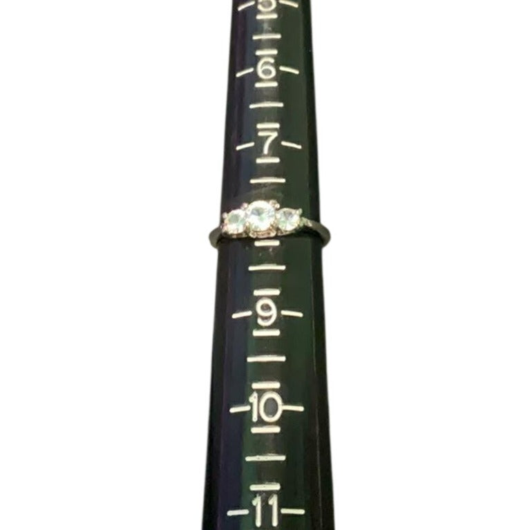 black ring sizer with three stone ring