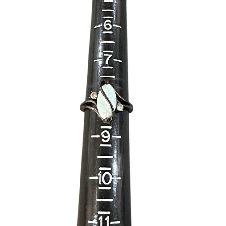 Close-up of a ring on sizer measurement markings on a white background
