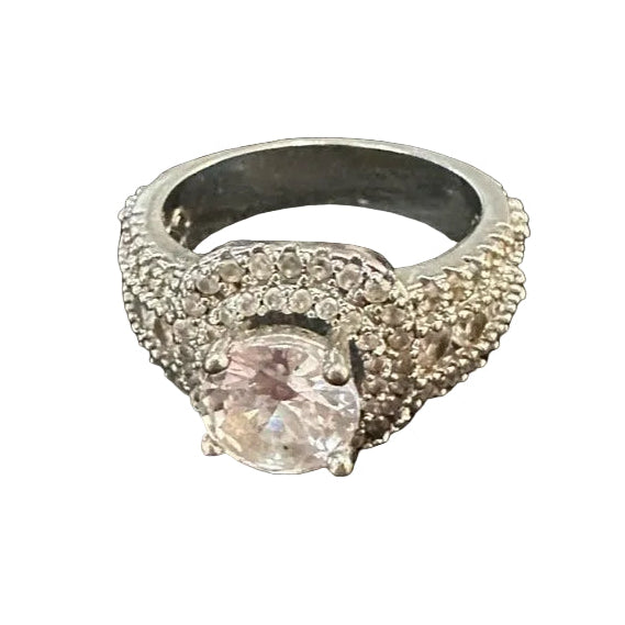 Silver ring with a central gemstone on a white background