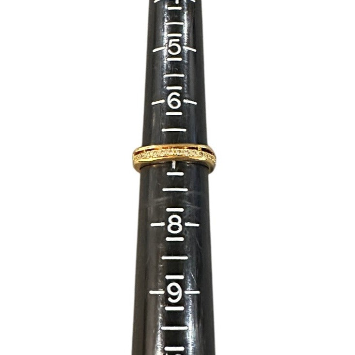 Black ring sizer with gold ring and measurement markings on a white background