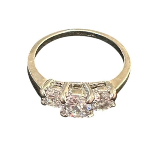 Gold ring with three diamonds on a white background