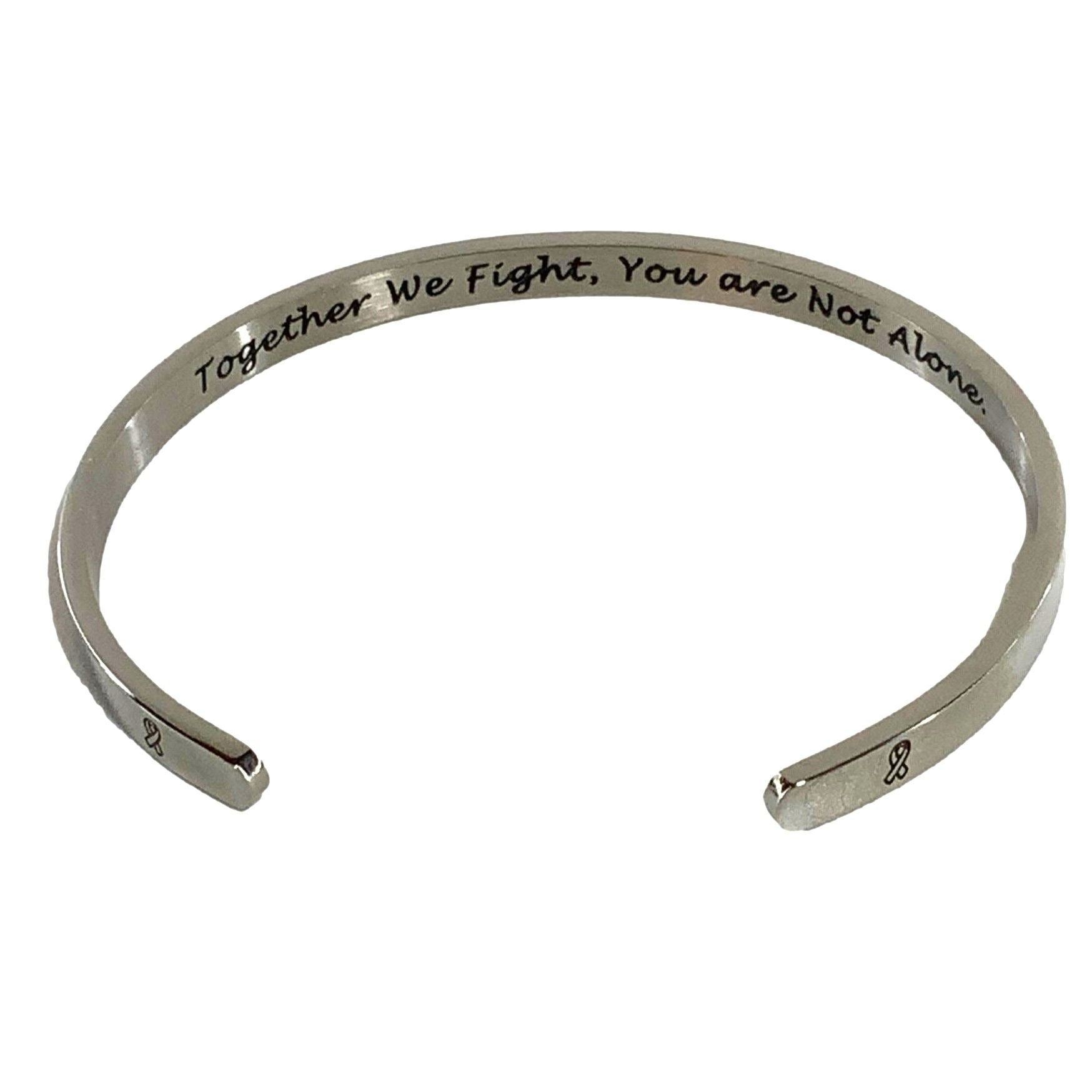 Silver bracelet with engraved text on a white background