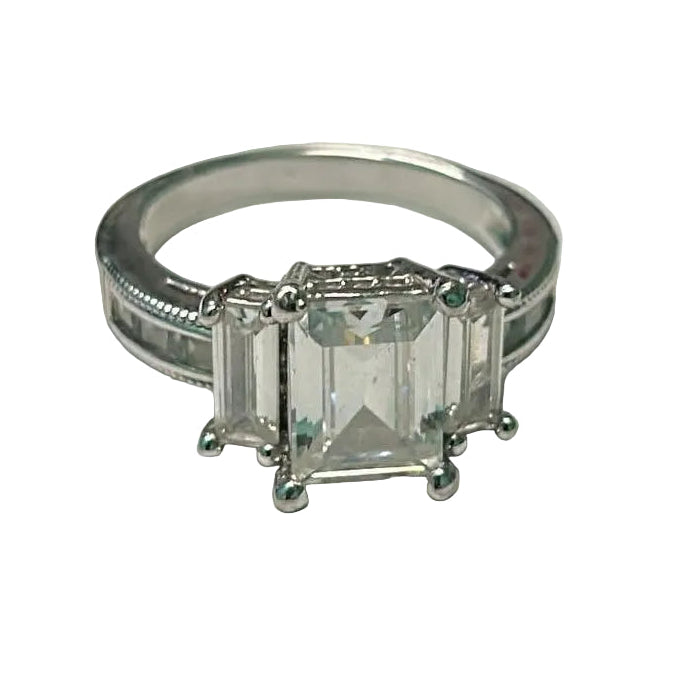 Silver ring with a rectangular gemstone on a white surface