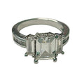 Silver ring with a rectangular gemstone on a white surface