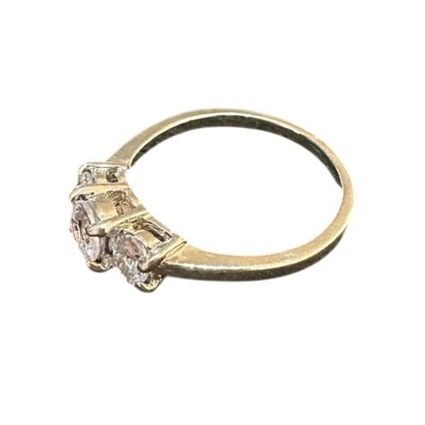 Gold ring with two diamonds on a white background