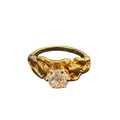 Gold ring with a diamond on a white background